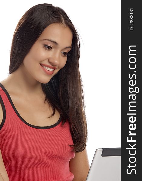 View of nice young girl sitting behind the laptop. View of nice young girl sitting behind the laptop