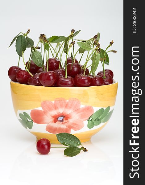 Fresh cherry with green leaf in platter. Fresh cherry with green leaf in platter