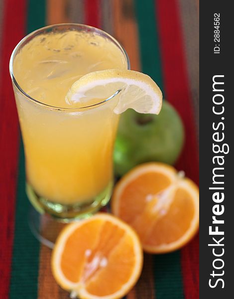 Orange and apple juice drink in a glass with ice