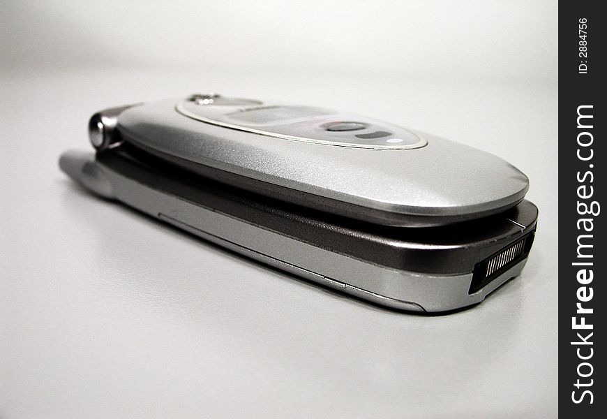 Open mobile clamshell phone on a neutral background