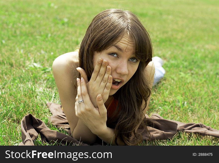 Girl lying on a green grass. Girl lying on a green grass