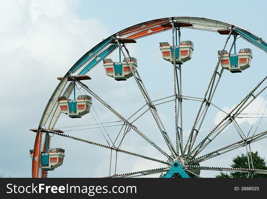 Ferris wheel against bule sky with clouds