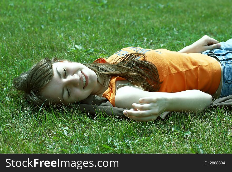 Girl lying on a green grass. Girl lying on a green grass