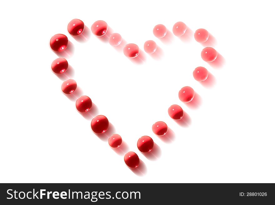 Love concept. Heart shape made from pink drops on white background. Clipping path is included. Love concept. Heart shape made from pink drops on white background. Clipping path is included