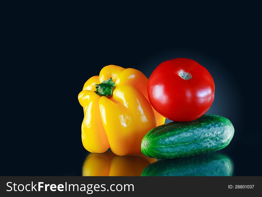 Color vegetables on dark background with reflection