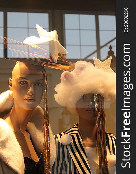 Christmas fashion shown by two models placed in the window and reflex in glass. Christmas fashion shown by two models placed in the window and reflex in glass