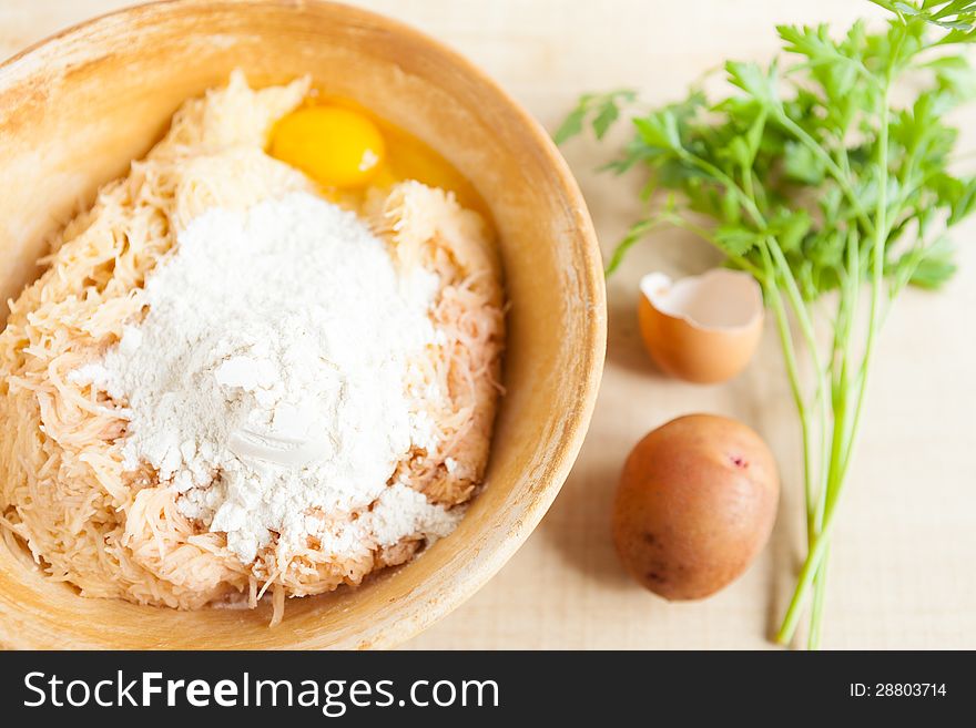 Grated Raw Potatoes, Eggs And Flour In A Large Bowl