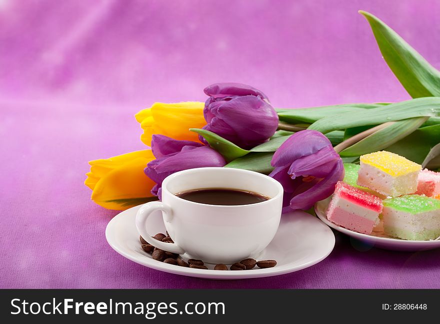 Flowers, coffee and sweets. Closeup