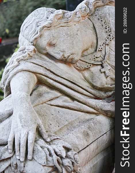 Statue of woman on tomb as a symbol of depression pain and sorrow. Statue of woman on tomb as a symbol of depression pain and sorrow