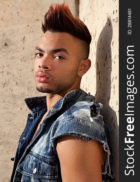 A portrait of an attractive young man outside, looking tough. A portrait of an attractive young man outside, looking tough