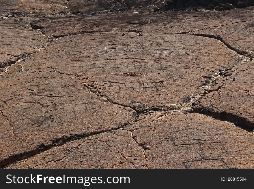 Native Hawaiian petroglyph pictograph carvings of symbols and figures in solidified lava. Native Hawaiian petroglyph pictograph carvings of symbols and figures in solidified lava.