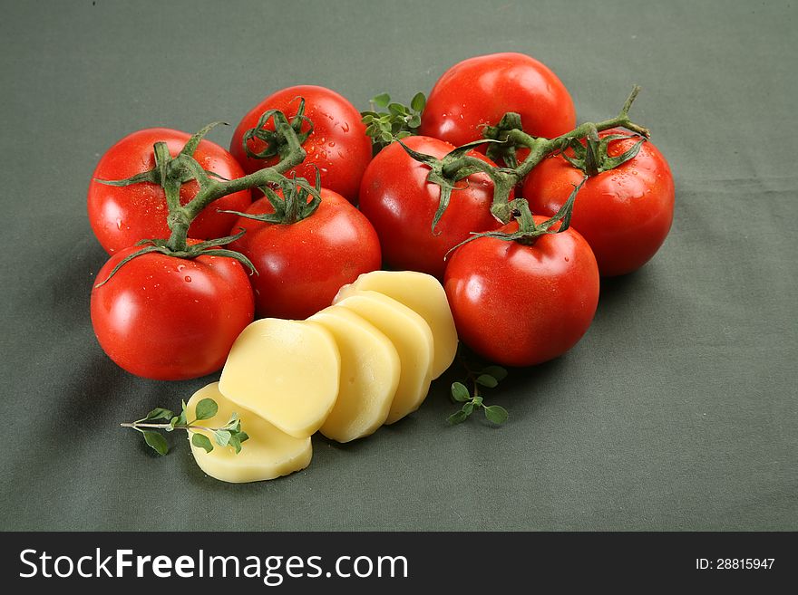 Sliced mozarella and fresh tomato on neutral background. Sliced mozarella and fresh tomato on neutral background