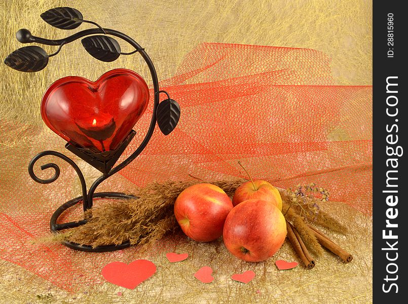 Red candlestick with apples and paper hearts. Red candlestick with apples and paper hearts