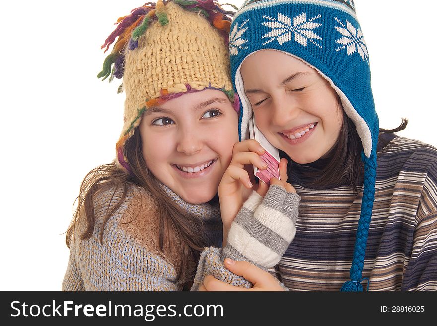 Beautiful young girls in warm winter clothes speaking on a mobil