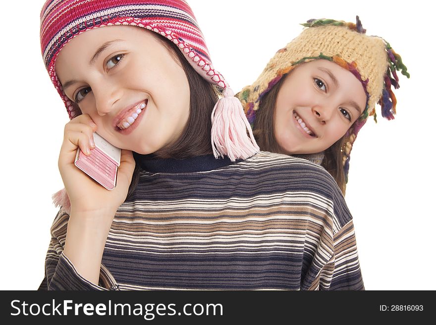 Beautiful young girls in warm winter clothes speaking on a mobile
