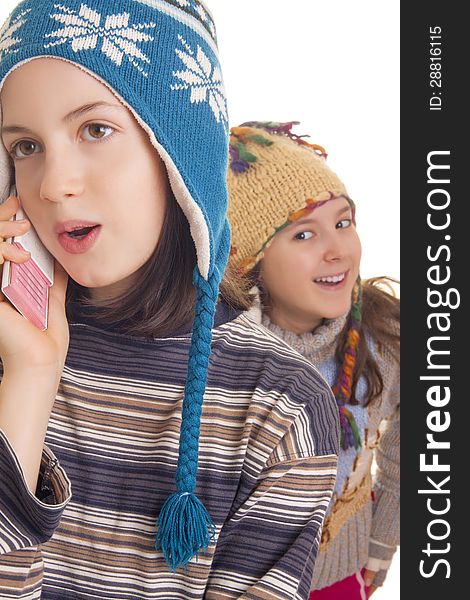 Beautiful young girls in warm winter clothes speaking on a mobile