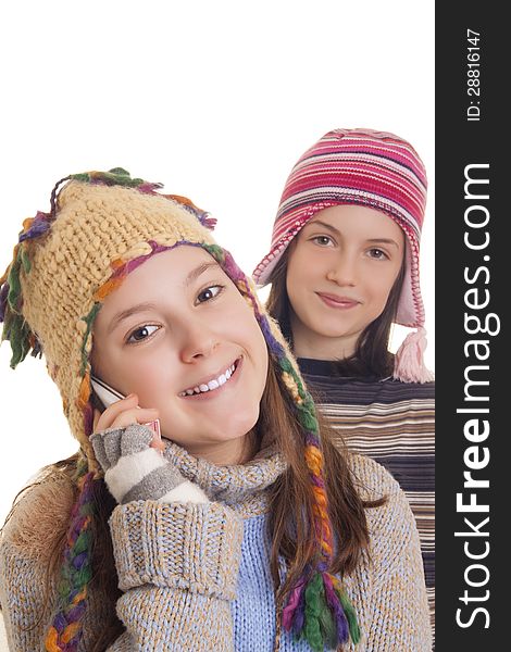 Beautiful young girls in warm winter clothes speaking on a mobile