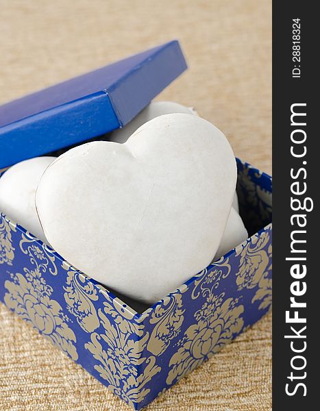 Cake with icing in the form of heart in a gift box, selective fo