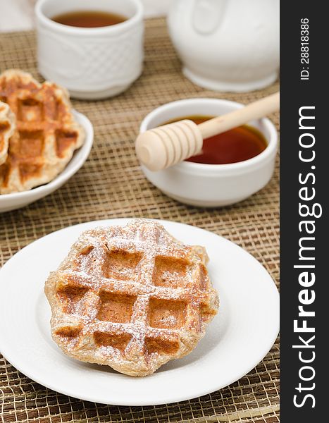 Homemade waffles topped with powdered sugar for breakfast