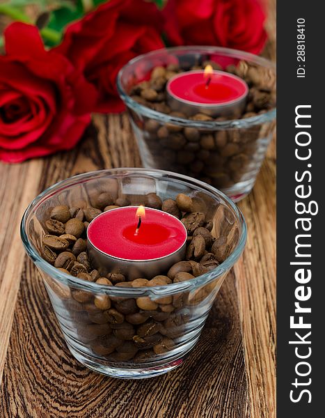 Red candles in glass jars with coffee beans