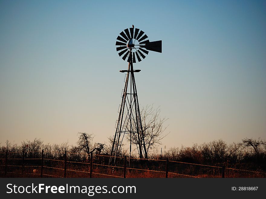 Bared Wire Fence And Water Windmill