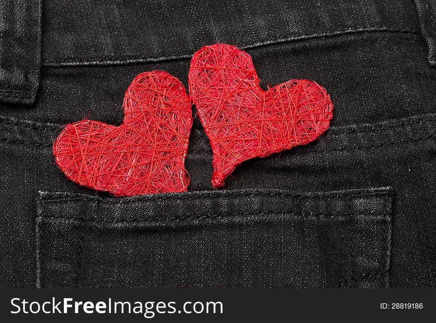 Two red hearts in a pocket black jeans