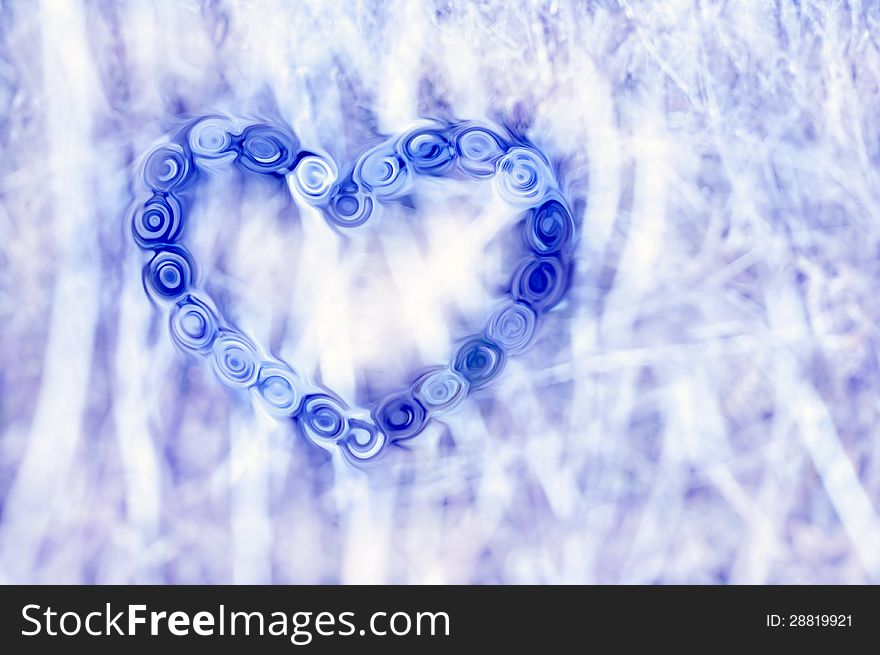 One blue heart consisting of liquified details on a light dappled background. One blue heart consisting of liquified details on a light dappled background