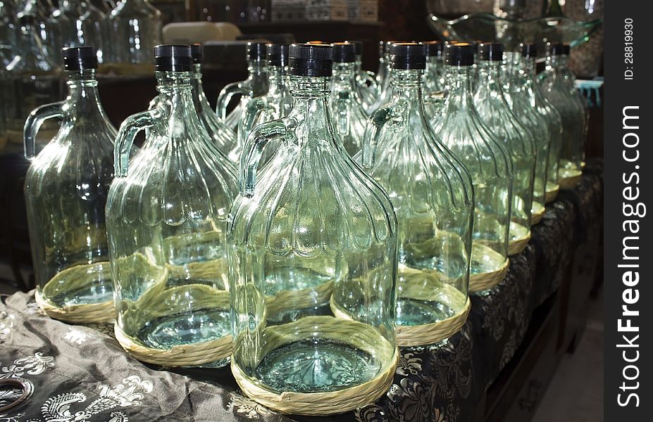 Large glass bottles prepared for bottling olive oil