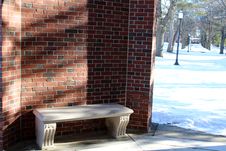 Stone Seat In Curve Of Brick Wall Stock Images