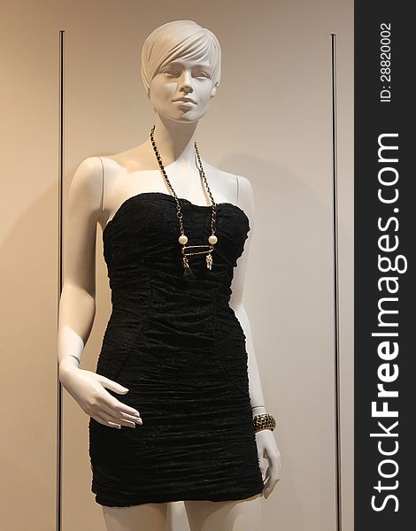 black dress presented by a plastic mannequin. black dress presented by a plastic mannequin