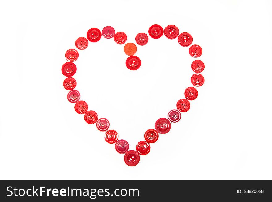 Heart from red buttons on a white background