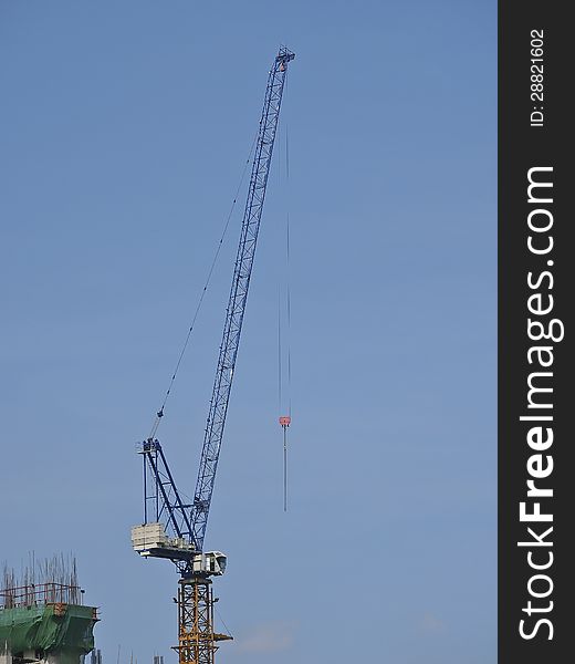 High crane stand in blue sky. High crane stand in blue sky