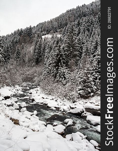 A winter landscape with river and mountain in the background. A winter landscape with river and mountain in the background