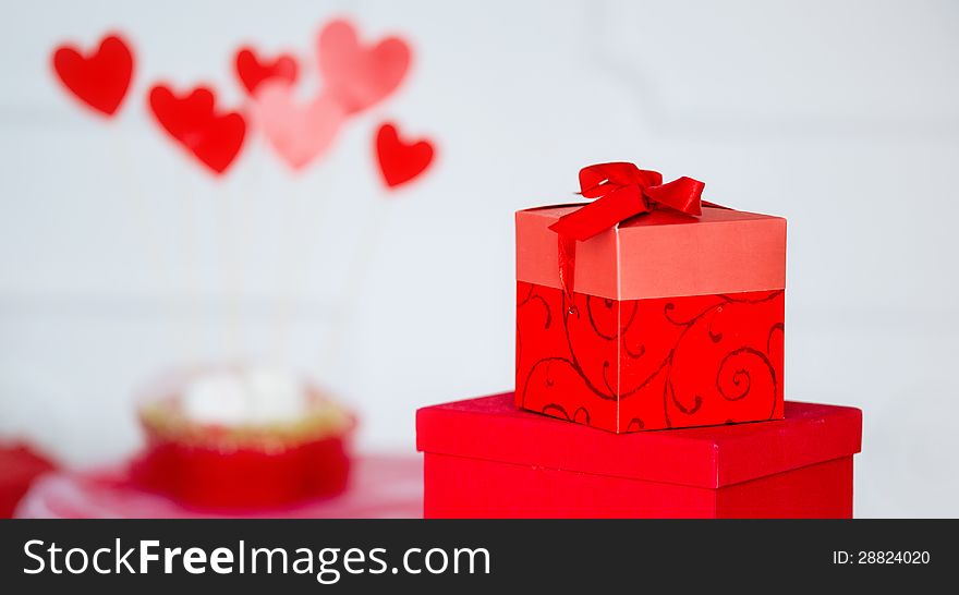 Valentine's hearts and red present box isolated on white. Valentine's hearts and red present box isolated on white