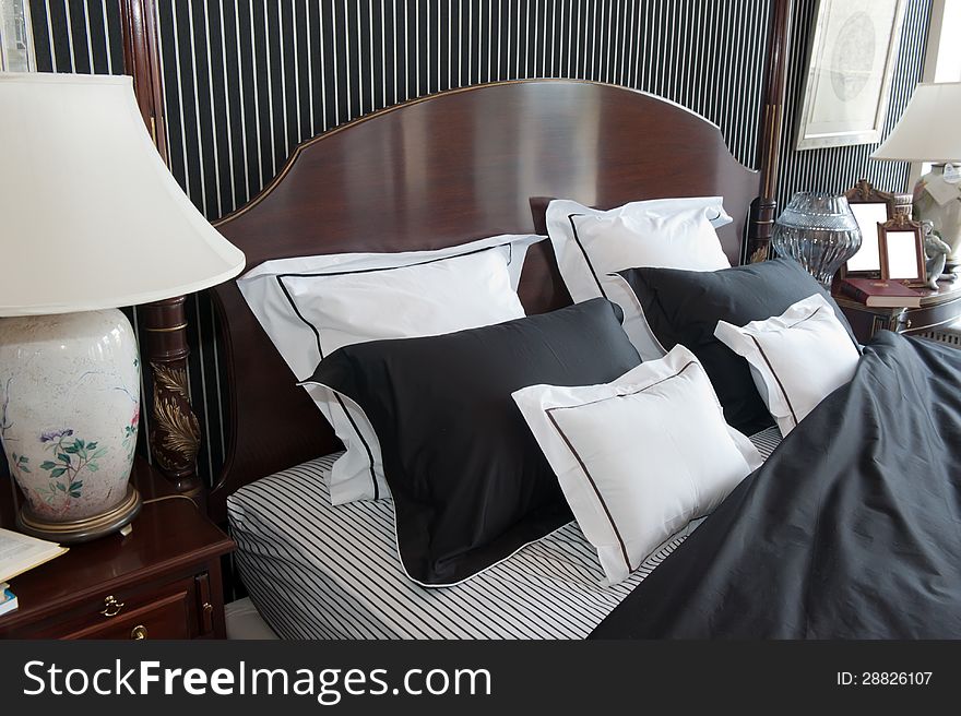 Interior of a modern bedroom. Bed, bedside tables, pillows.