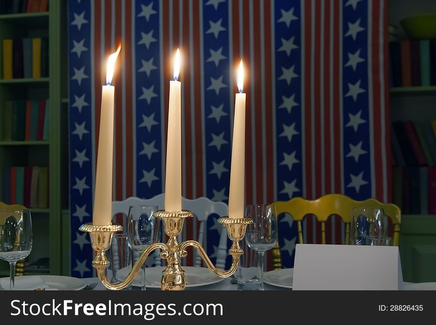 Three burning candles on a stand against the U.S. merchandise. Three burning candles on a stand against the U.S. merchandise.