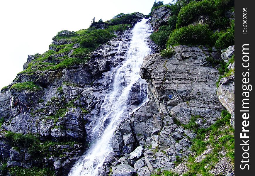 A waterfall is a place where water flows over a vertical drop in the course of a stream or river.