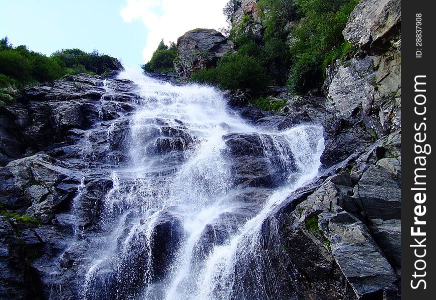 A waterfall is a place where water flows over a vertical drop in the course of a stream or river.