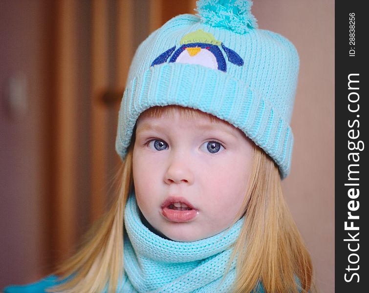 Portrait of Cute little girl in blue hat