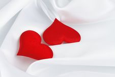Two Red Hearts On White Silk Stock Photography