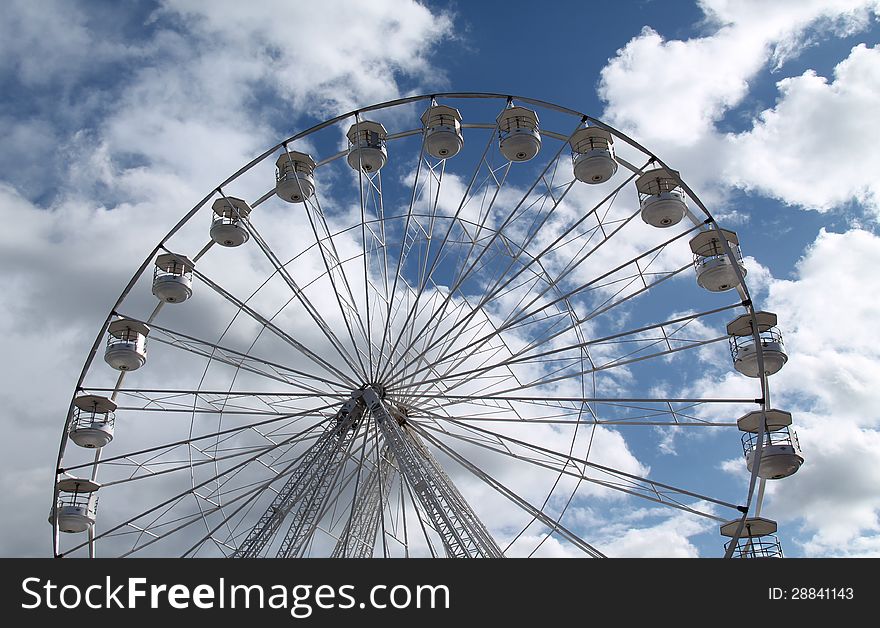 A Fun Fair Big Wheel with a Dramatic Cloud Background. A Fun Fair Big Wheel with a Dramatic Cloud Background.