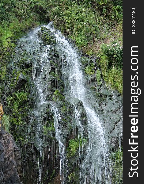 A Waterfall Falling Down a Coastal Cliff. A Waterfall Falling Down a Coastal Cliff.