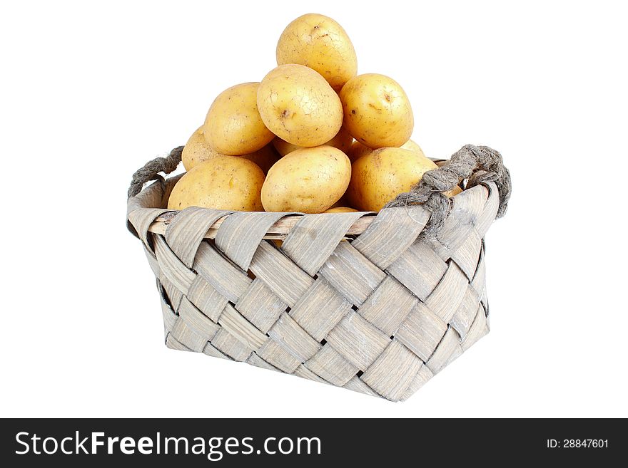 Stack of potatoes in basket , isolated on white