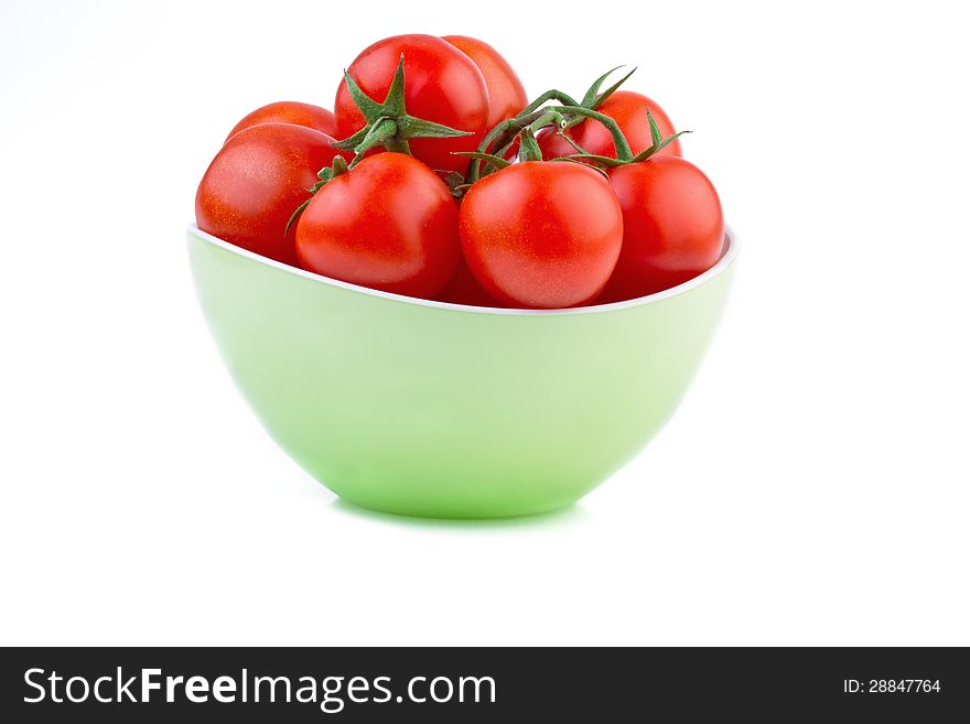 Fresh tomato in green bowl   on white