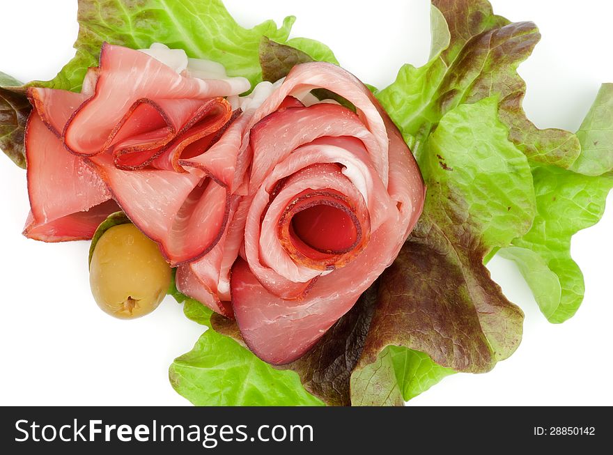 Arrangement of Jamon and Greens with Olive closeup on white background. Top View