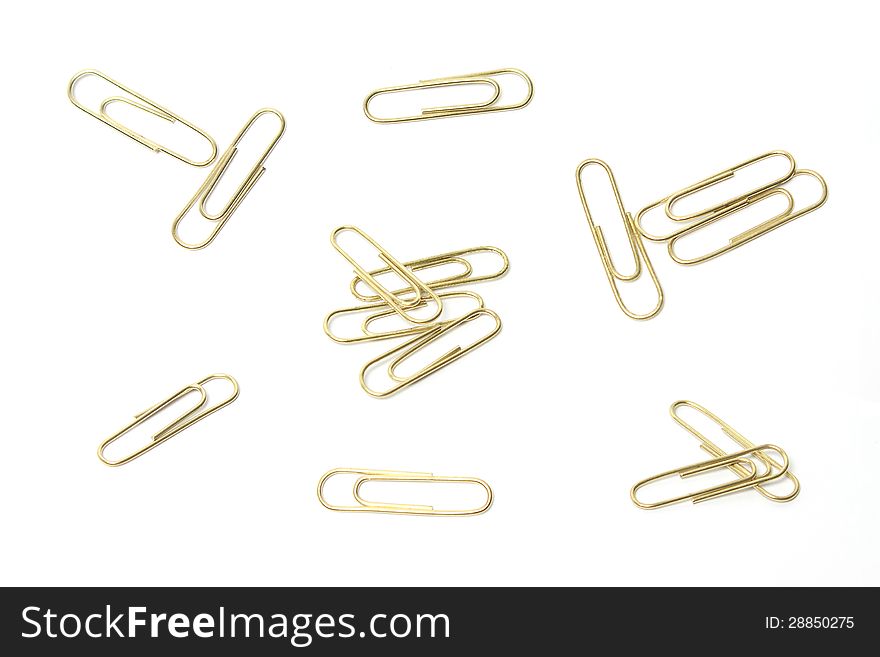 A group of isolated brass paperclips from different angles. A group of isolated brass paperclips from different angles