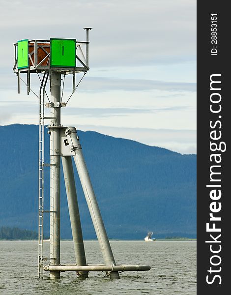 One of the many channel and navigation marker aides to help boats, ships and other maritime vessels safely navigate in Auke Bay, near Juneau Alaska. One of the many channel and navigation marker aides to help boats, ships and other maritime vessels safely navigate in Auke Bay, near Juneau Alaska.