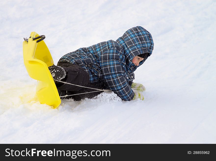 Little boy on sleigh - doing an overturn crash. Little boy on sleigh - doing an overturn crash