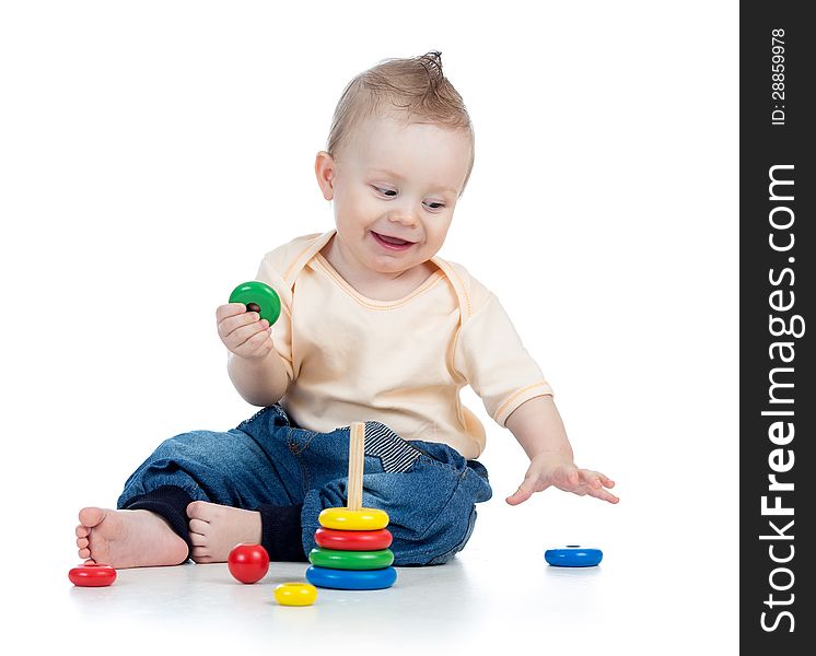 Happy baby boy playing with colorful toy on white