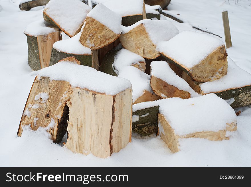 Pile of firewood covered by snow